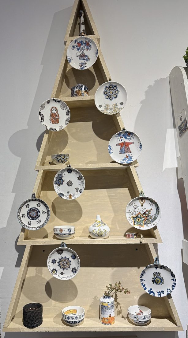 Hand-painted ceramic plates and vases on a display stand